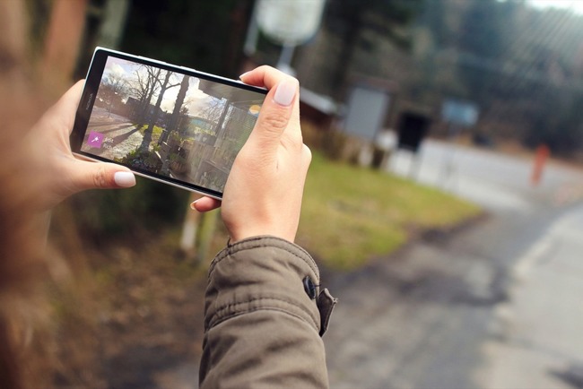 Фото улицы на телефоне в руках человека